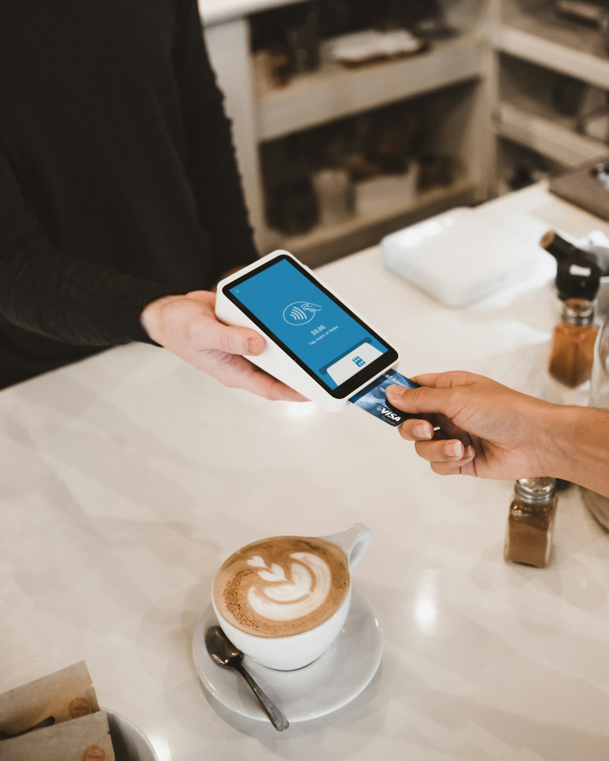 Woman smiling while holding phone and credit card